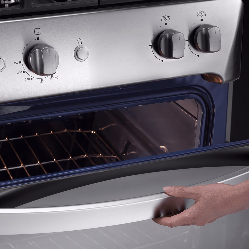 Puerta de horno abierta de cocina a gas Indurama Turin Zafiro mano abriendo manija primer plano granhogar